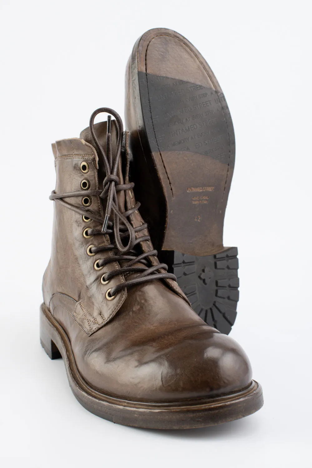 CURZON husk-brown military boots.