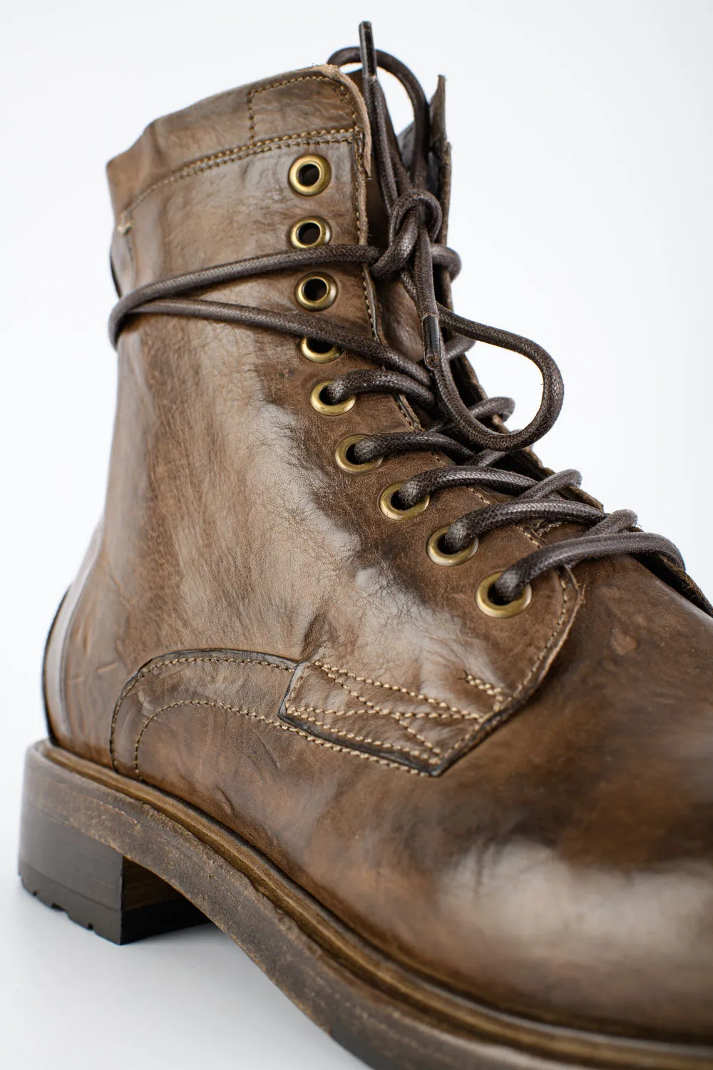 CURZON husk-brown military boots.